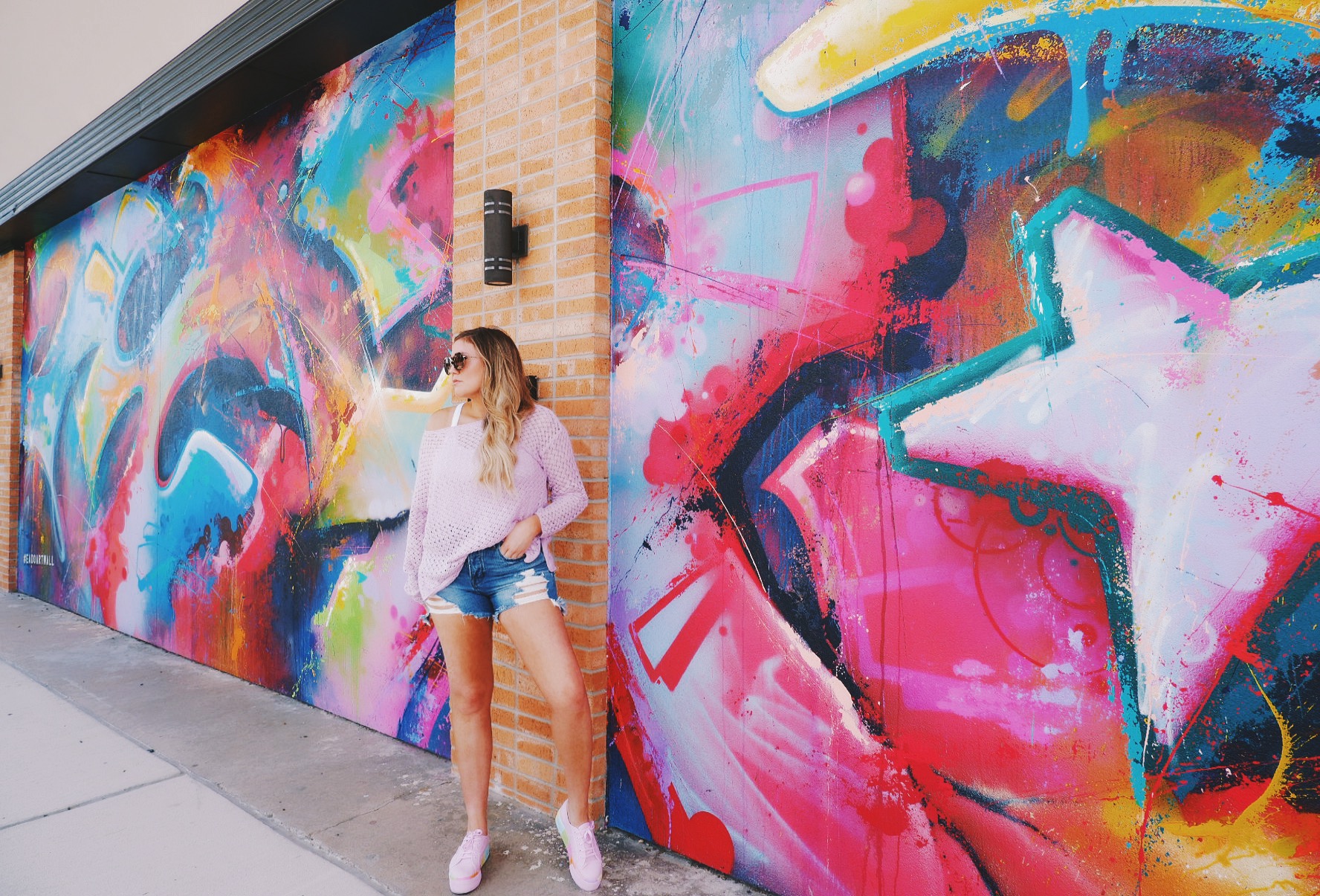 Purple-sweater-distressed-jeans-shorts-rainbow-sneakers